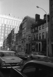 A black and white photograph of the 700 block of Sansom Street in Philadelphia. 