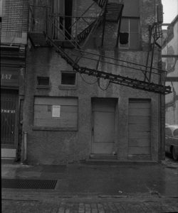 A black and white photograph of a rowhouse in Philadelphia to be demolished to make way for the Philadelphia Police Administration Building.