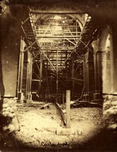 A black and white photograph of the interior construction of the cathedral.