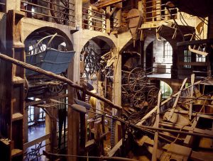 This color photograph shows several levels of the Mercer Museum. Objects and tools cover nearly every inch of open space, many of them made out of wood.