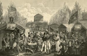 a black and white engraving of a crowd of revelers at Center Square, now Penn Square, Philadelphia in 1819. Different tents on the grounds feature musicians, games, and groups of women. Two uniformed soldiers stand arm in arm together in the front center. There are American flags and a portrait of George Washington displayed. A round pump house stands in the background surrounded by a marching band.