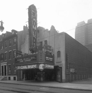 A black and white photograph of the facade of the Boyd Theater, a 1920s-era Art Deco style movie palace. The facade is of carved white granite and an ornate entryway frames a central ticket booth. A large vertical sign on the front reads "BOYD" and a marquee advertises "Theodore Dreisers Novel Jennie Gerhart" and "Sylvia Sidney in Jennie Gerhart". A banner beneath the marquee reads "Its Cool Inside!"