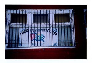 A color photograph depicting a sign with a Cuban flag and the text "Cuban Community Center."