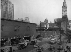 Photograph of Market Street and the Chinese Wall with trains running on it.