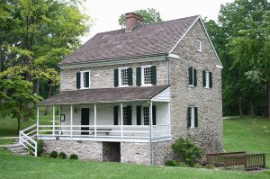 A color photograph of the Hager House, a two-story stone residence with a large front porch.