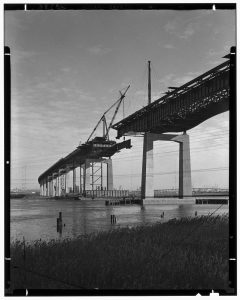 A 1951 photograph depicts the construction of a bridge along the New Jersey Turnpike.