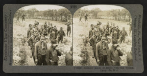 World War I recruits fit with gas masks are about to enter a tear gas trench