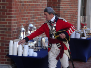 A smartly garbed reenactor enjoys beverages at the Museum of the American Revolution dedication ceremony.