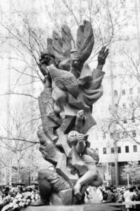 This black and white photo depicts the Monument to Six Million Jewish Martyrs in detail. There are many faces and hands reaching skyward.