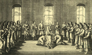 an illustration showing a Moravian church with a large baptismal pool in the center. Native American men and women stand along the sides of the hall watching as three Native American men kneel at the pool. A caucasian man pours water over one of the kneeling men's heads.
