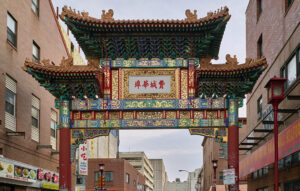 Photograph of the China Gate at Tenth and Arch Streets, which is adorned with dragon motifs, small animal sculptures, and ornamental roof tiles