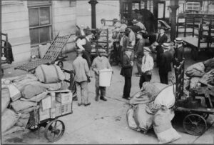 Black and white photograph of men surrounded by piles of mail bags